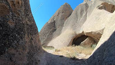Carved chambers and cave houses sit among Cappadocia fairy chimneys in Goreme, turkiye, subterranean corridor, masonry chamber