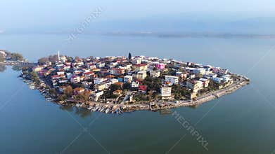 Aerial drone view of Golyazi village on narrow peninsula linked by thin road across lake, bursa, turkiye, mosque, houses