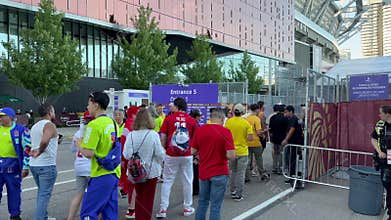 Soccer fans queue at a BC Place stadium gate during FIFA World Cup