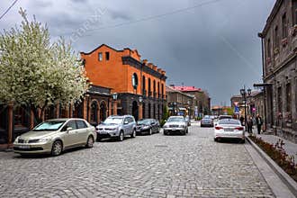 Urban street scene with vintage architecture and stone pavement