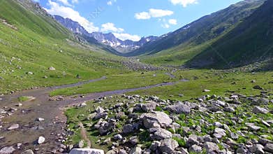 Aerial Kackar Mountains Turkey valley stream and green meadows open across treeless alpine terrain, water, rocks, creek, turkiye