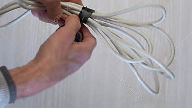 Carefully encircling coiled extension with tape to ensure tidy storage and protection