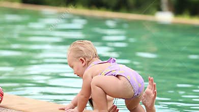 Mother and daughter swim in the pool