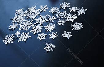 White paper snowflakes on dark blue background
