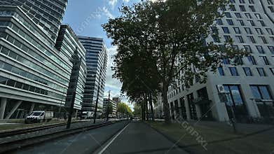 Low-angle view of modern office towers and tram lines above city