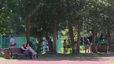 Happy families playing water fight in park