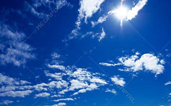 Sun and clouds on blue sky