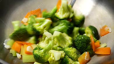 Close up of a woman cooking vegetables