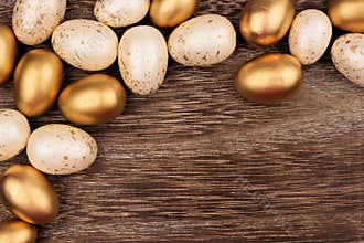 White and gold Easter egg corner border over rustic wood