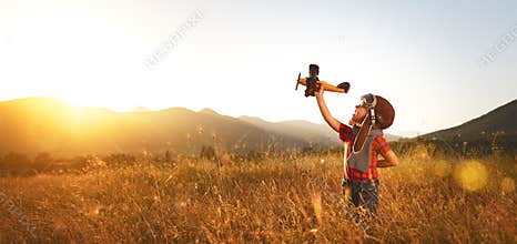 Child pilot aviator with airplane dreams of traveling in summer
