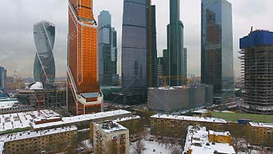 Contrast of poverty with wealth. Old houses with skyscraper on background.