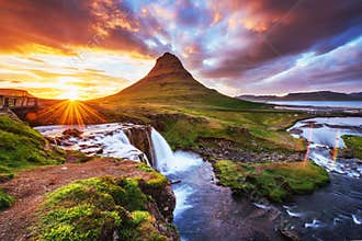 The picturesque sunset over landscapes and waterfalls. Kirkjufel