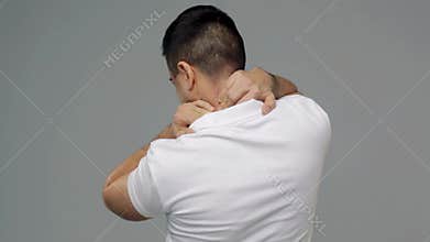 Unhappy man suffering from neck pain
