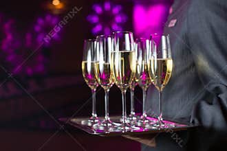 Waiter serving champagne on a tray