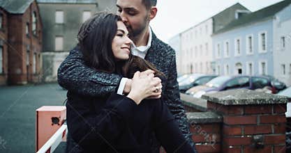 Young attractive tourist couple embracing and kissing in a romantic destination city. 4k