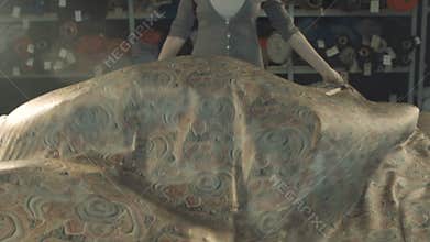 Silk fabric develops beautifully. Female in the workshop. Slow motion