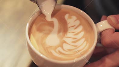 Amazing barista tutorial of making art latte, shape of a swan. Female hands, portrait. Inside shooting. Cafe business