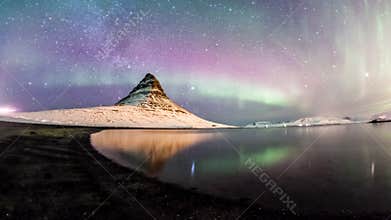 The Northern Lights and winter milky way over Kirkjufell