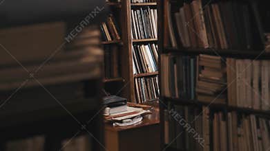 Bookcases full of books and document folders in old style library. Dolly shot