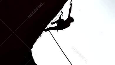 Silhouette of climber on a rock with complex route