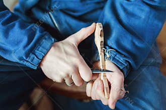 A man working with woodcarving instruments