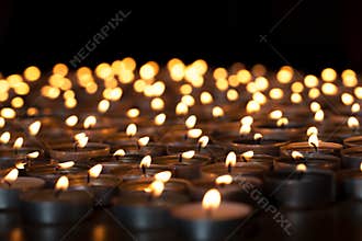 Flaming candles. Spiritual image of tealights providing sacred l