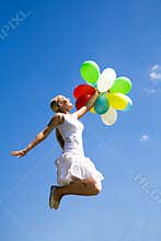 Woman jumping with balloons