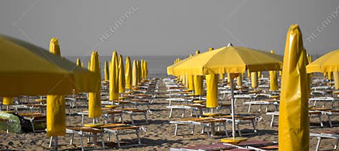 The yellow umbrellas on the beach in the morning still deserted