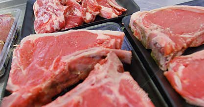 Raw red meat in container