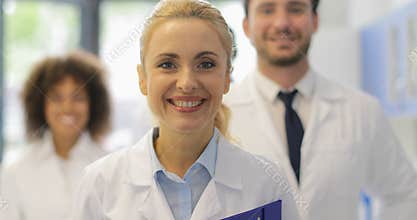 Happy Smiling Woman Walking With Team Of Doctors In Modern Laboratory Successful Researchers Group