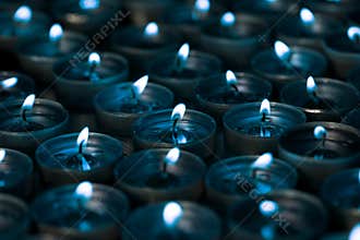 Nightlight. Lighted tea light candles at night with a silver blu