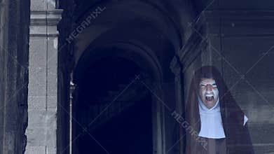 The ghost of a nun walks through the ruins of an old monastery. 4 k. Slow-motion shooting