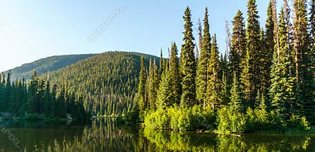 Mountain lake in mountains at sunny day British Columbia Canada.