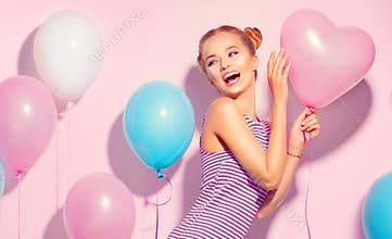 Beauty joyful teenage girl with colorful air balloons having fun