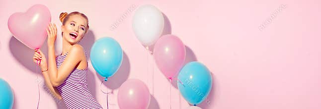 Beauty joyful teenage girl with colorful air balloons