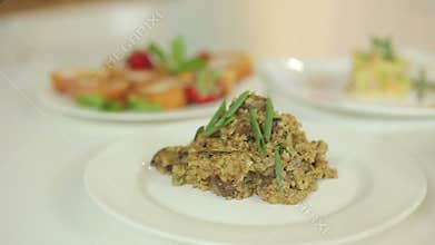 Appetizing soup with potatoes and rice, risotto from pearl barley and chicken hearts. Presentation of ready meals.