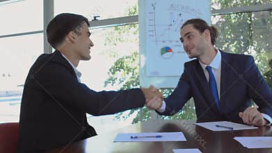 Two businessmen makes a deal in the office