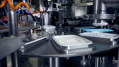 Automated production line of milk products at cheese plant.