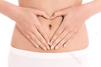 Woman forming heart shape on belly