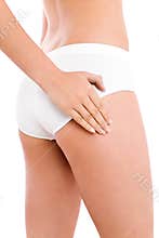 Slim woman touching her thigh