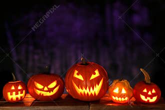 Halloween Jack o Lanterns at night against a spooky background