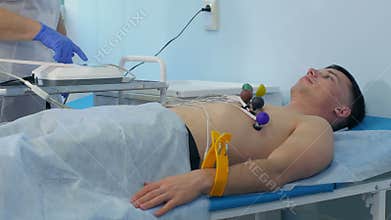 Nurse performing ECG on a male patient