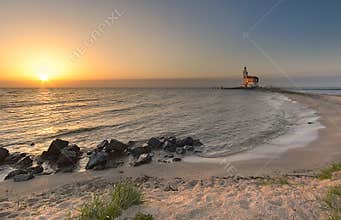 Beach and lighthouse in sunset colors