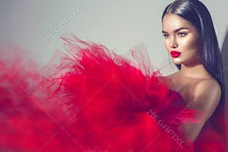 Gorgeous brunette model woman in red dress
