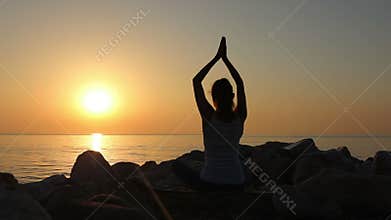 Morning meditation, woman practices yoga on the seashore, Shot on Canon EOS 5D Mark IV in Slow Motion