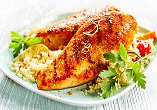 Grilled poultry with couscous on plate
