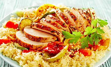 Poultry cut in slices among couscous