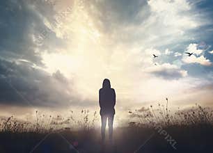 Human Silhouette Standing Under Dramatic Sky With Light Of Hope