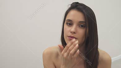 Girl applies facial treatment