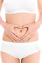 Woman forming heart shape on belly